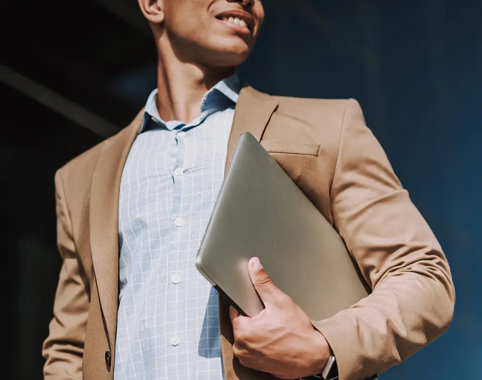 IT executive holding a laptop,