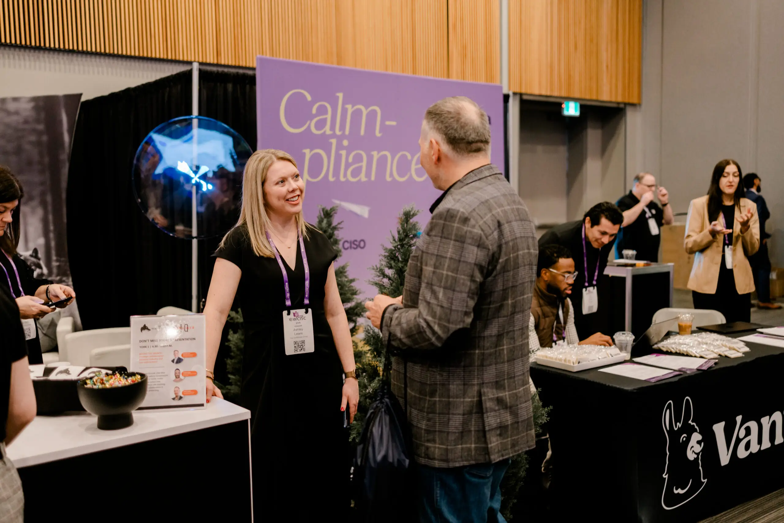 WolfStrata staff speaking to clients and partners from a booth at an IT conference.